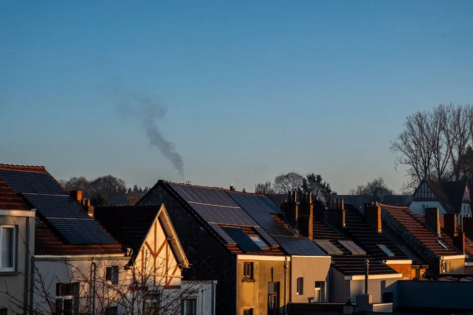 UK homes with rooftop solar panels and a working chimney in winter