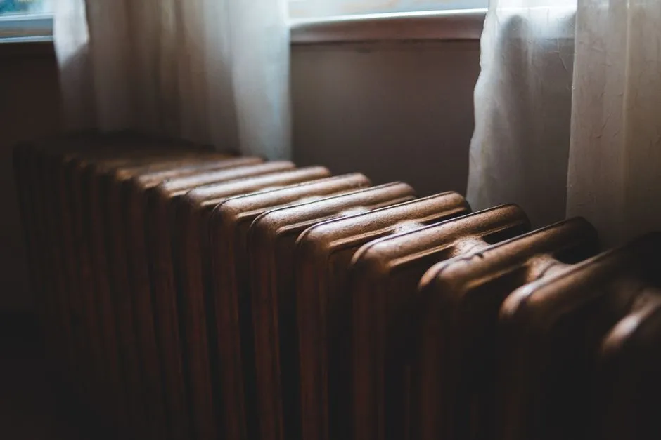Traditional radiator beneath a window in a rented home