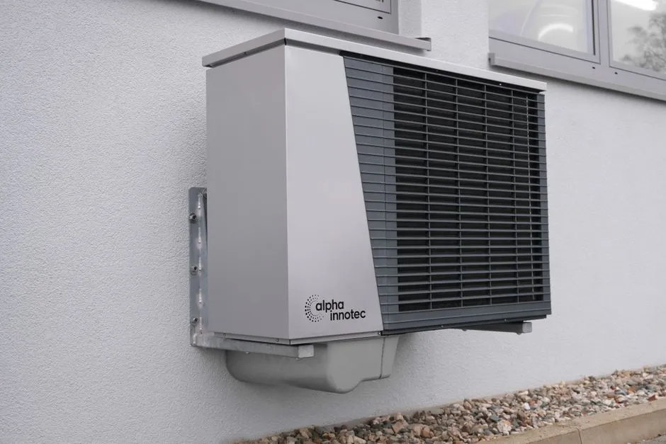 Air source heat pump installed beside a UK home