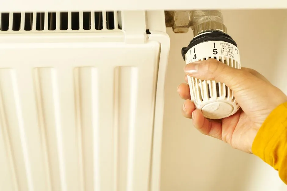 Tenant adjusting a thermostatic radiator valve in a rented UK home