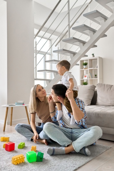 Happy family enjoying warm underfloor heating in their home